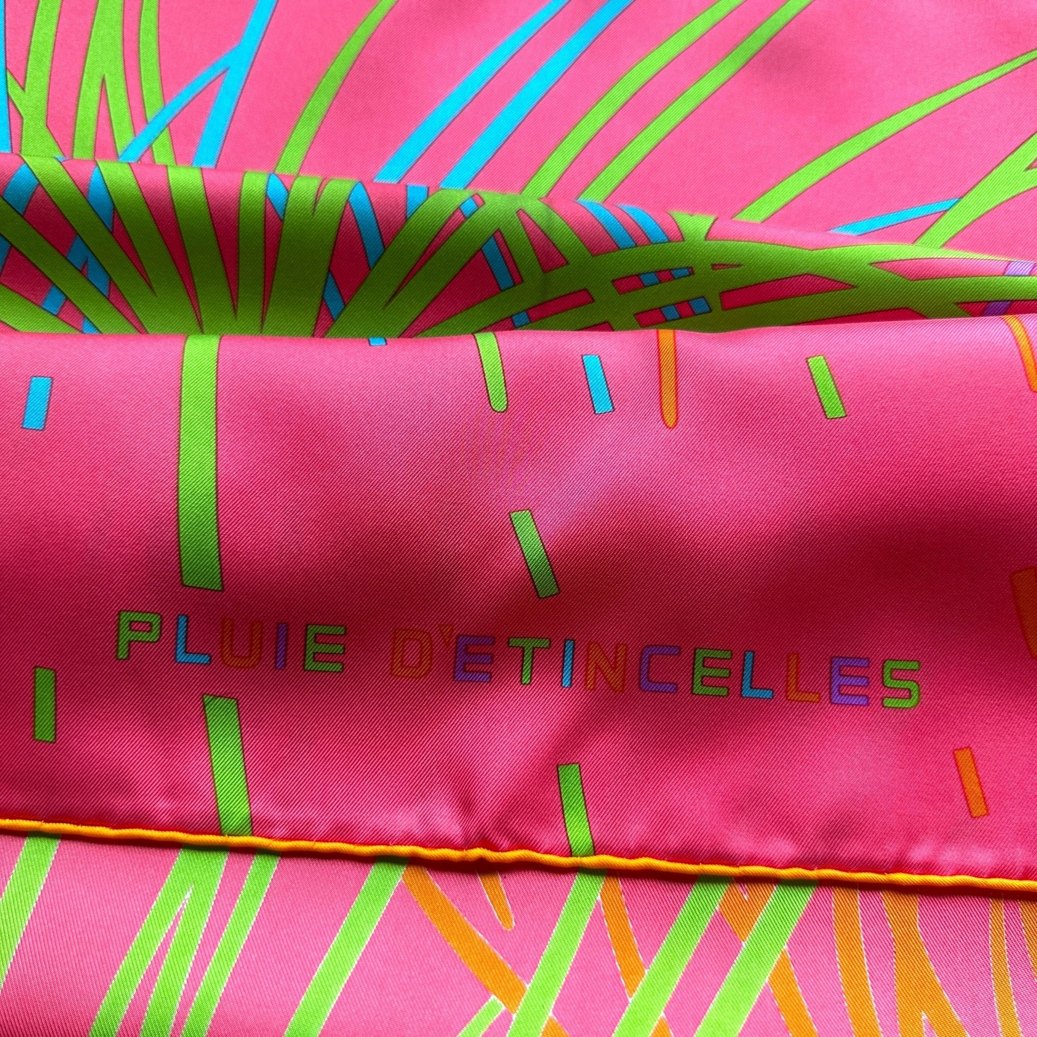 Zoom du titre du foulard Hermès Pluie d'Étincelles présenté avec un effet plissé